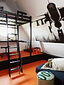 Child's attic bedroom with large aeroplane poster on sloping wall
