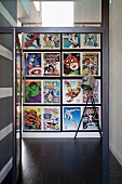 Modern hallway with stamp-style Marvel comics wallpaper and studio lamp