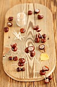 Figures made of conkers and toothpicks on chopping board