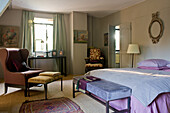Schlafzimmer mit antiken Möbeln, Gemälden und orientalischem Teppich