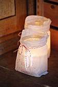 Candle lanterns made from mason jars and paper bags with hand-written mottos