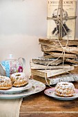 Old books stacked on table set with small bundt cakes