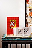 Books, picture with Lego frame & retro clock on bedside table made from drinks crate