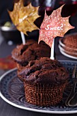 Chocolate muffins with toppers made from painted autumn leaves