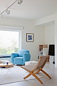 Pale blue armchair in Scandinavian interior with minimalist furnishings