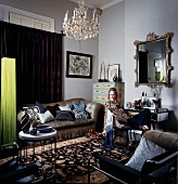 Velvet sofa, mirror and Chinese silk rug in living room; woman sitting in armchair