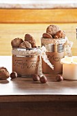Christmas biscuits in tin cans with hand-written labels and nuts on table