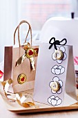 Two elegantly packed gift bags decorated with upcycled bottle tops