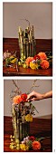 Arranging autumn flowers and knotweed stems in glass vase