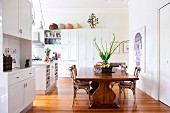 Large dining table and wooden chairs in open-plan kitchen