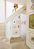 Open-plan stairwell with framed pictures on wall