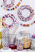 Party buffet with colourful confetti wreaths decorating wall