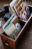 Collection of postcards and bookmarks in vintage wooden crates on wooden surface