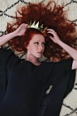 Red-haired woman with golden crown in hair