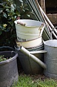 Various buckets and watering cans in garden