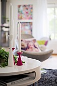 Set of pink and white candlesticks on coffee table