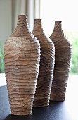 Still-life arrangement of hand-made wooden vases