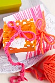 Simple gift box wrapped in colourful woollen yarn