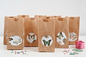 Butterfly motifs stuck on brown paper gift bags