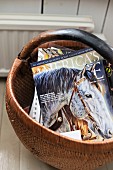 Horse magazine in basket on floor