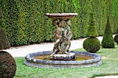 A fountain with stone figures and topiarised boxtrees (Palace of Versailles)