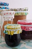 Jars of jam with covers upcycled from oilcloth remnants and ribbons