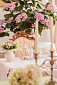 Set table in front of hydrangea in stylish restaurant