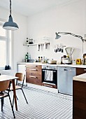 Large, bright kitchen in period apartment with mixture of DIY elements and vintage, flea market finds