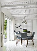 Dining area with upholstered chairs and postmodern table in interior with white wooden ceiling and floor
