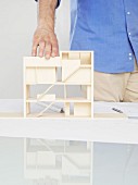 A man looking at an architectural model