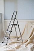 A step ladder and dust sheet