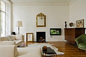 Elegant, pale living room with stucco frieze and fire in open fireplace of Victorian town house