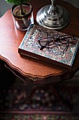 Reading glasses and book on delicate side table