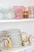 Crockery in white, shabby-chic, glass-fronted cabinet