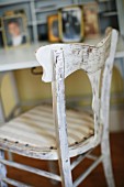 Vintage kitchen chair with white peeling paint