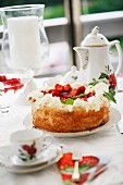 Strawberry cake with cream and coffee service with nostalgic pattern