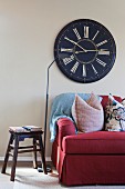 Cropped couch with large wall clock in living room