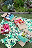 Picnic in garden with individually packed wooden crates used as picnic hampers