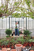 Couple smiling in greenhouse