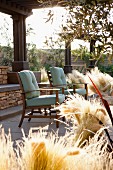 Armchairs and dried grass on patio