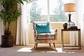 Blue throw pillow on armchair by window