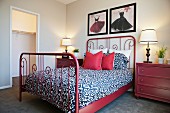 Wrought iron bed with red cushions; Valencia; California; USA