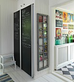 Fitted fridge with chalkboard doors and old window frame on wall