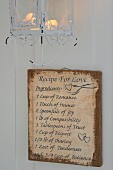 Vintage-style 'Recipe for love' painted on hessian below romantic wire-framed candle lantern