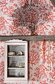 Vintage, glass-fronted cabinet on half-timbered wall with wallpapered panels