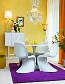 Gold wallpaper, Panton chairs and purple rug
