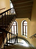 Stairwell with carved balustrade and semicircular half-landing in old house