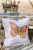 Hand-sewn cushion with nostalgic butterfly motif