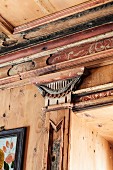 Artistic wood panelling in Italian chalet; pilaster with decorative capital and floral ornamentation