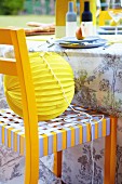Paper lantern on yellow and grey chair